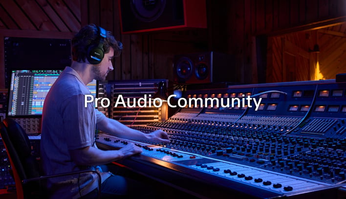 An audio engineer adjusting a mixing board in a recording studio