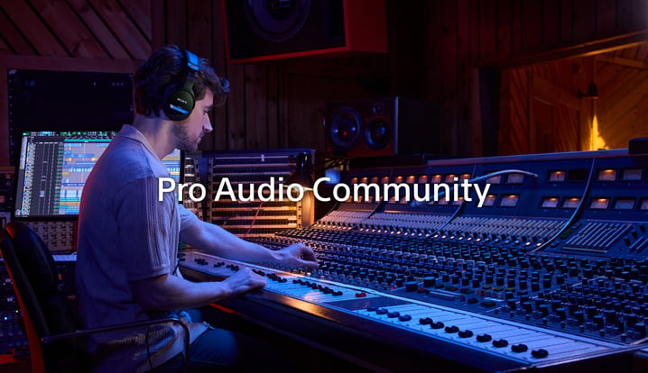 An audio engineer adjusting a mixing board in a recording studio